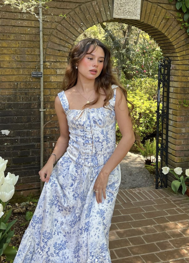 Floral print sundress summer brunch outfit with delicate accessories and natural waves.